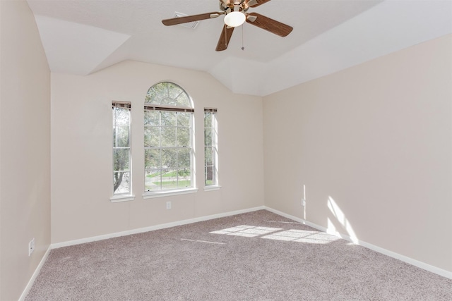 carpeted empty room featuring ceiling fan and vaulted ceiling