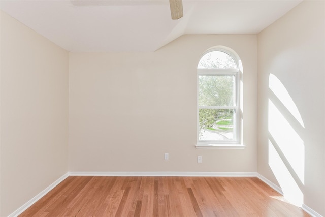 unfurnished room with light hardwood / wood-style flooring and lofted ceiling