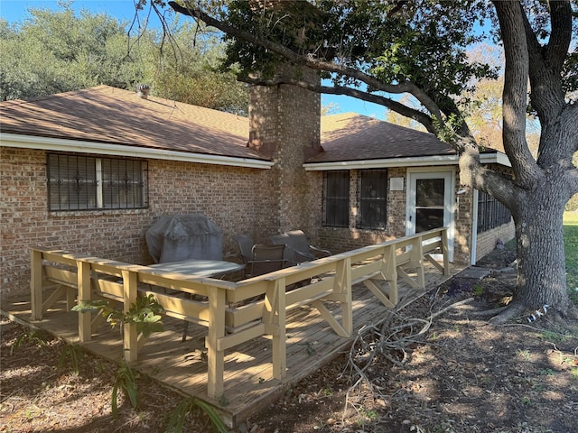 rear view of house featuring a deck