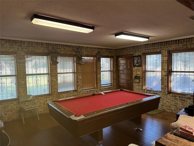 rec room with pool table, a healthy amount of sunlight, and brick wall