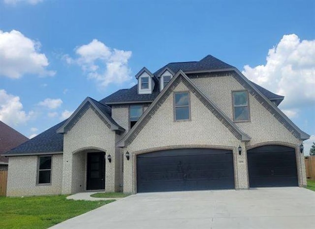 3090 Ethan Symone St, Beaumont, TX 77705 - french country inspired facade with a front yard and a garage