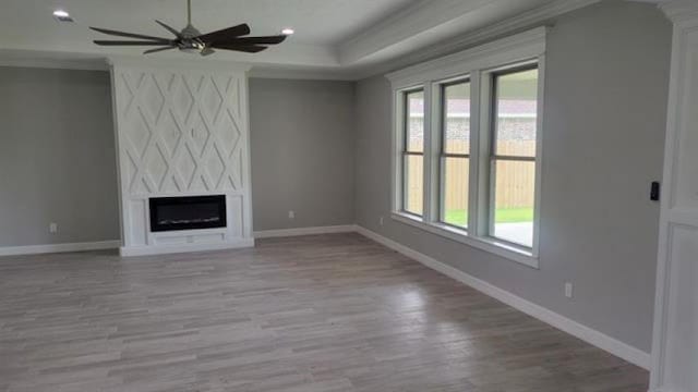 3090 Ethan Symone St, Beaumont, TX 77705 - unfurnished living room with a large fireplace, ceiling fan, and light hardwood / wood-style floors