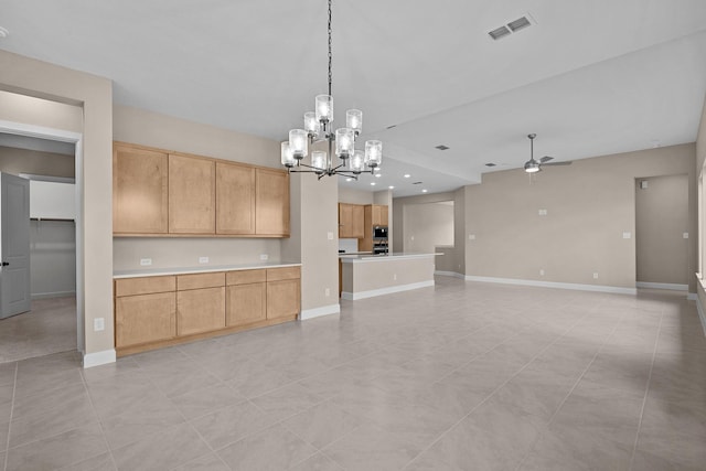 kitchen featuring light brown cabinets, light tile patterned flooring, hanging light fixtures, and ceiling fan with notable chandelier