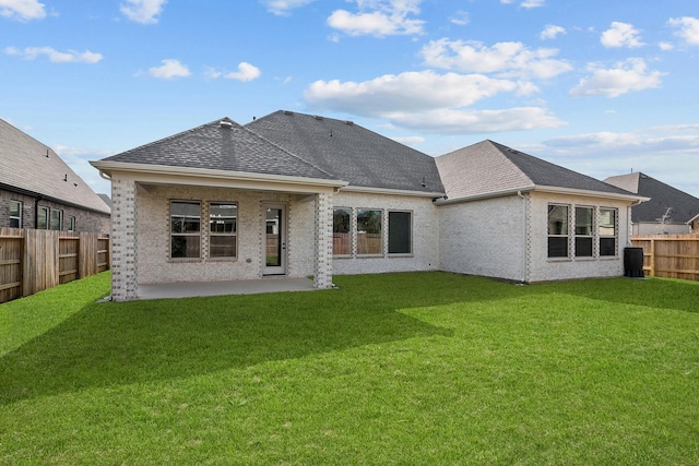 rear view of house featuring a yard and a patio area