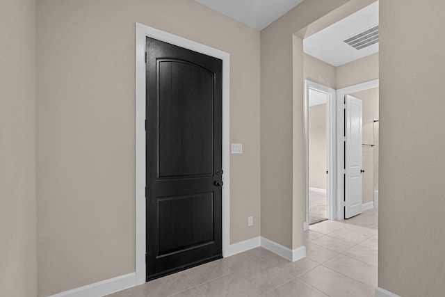 foyer entrance with light tile patterned flooring