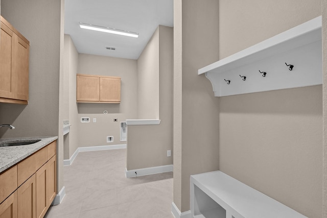 mudroom with sink and light tile patterned flooring