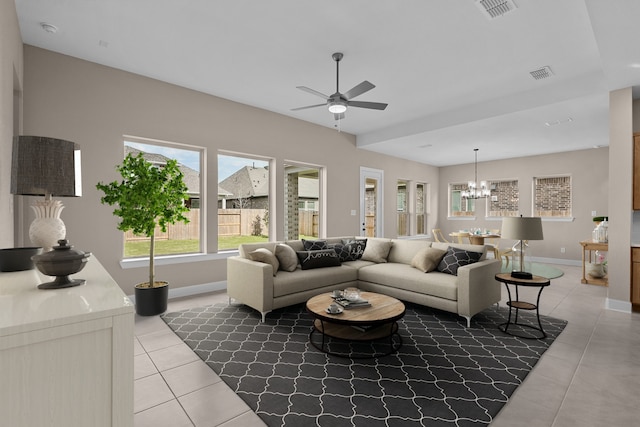 living room featuring ceiling fan with notable chandelier and light tile patterned flooring