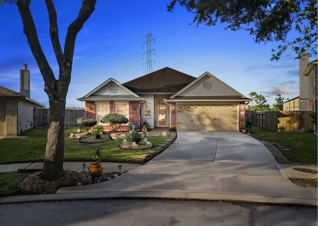 ranch-style home featuring a lawn and a garage