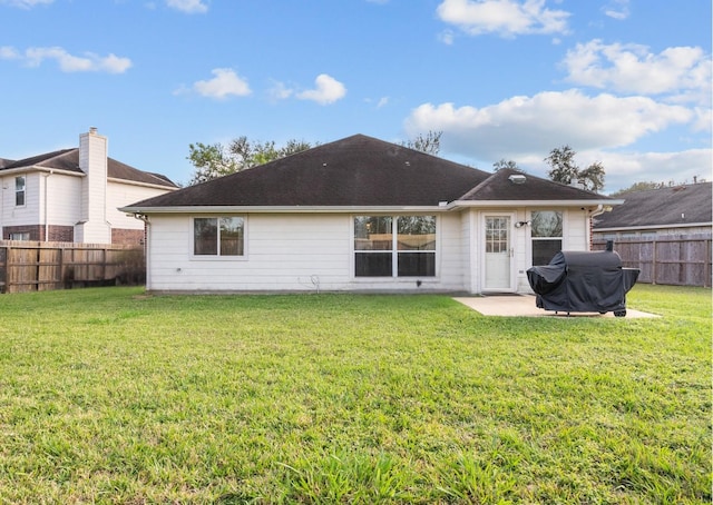 rear view of property with a yard and a patio