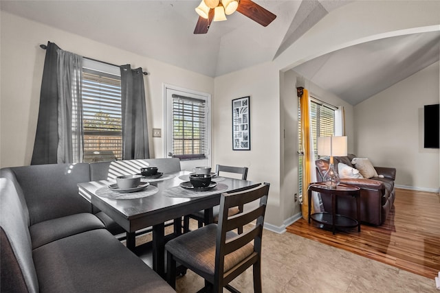 dining area with light hardwood / wood-style flooring, ceiling fan, and lofted ceiling