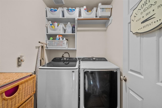 laundry room featuring washing machine and clothes dryer