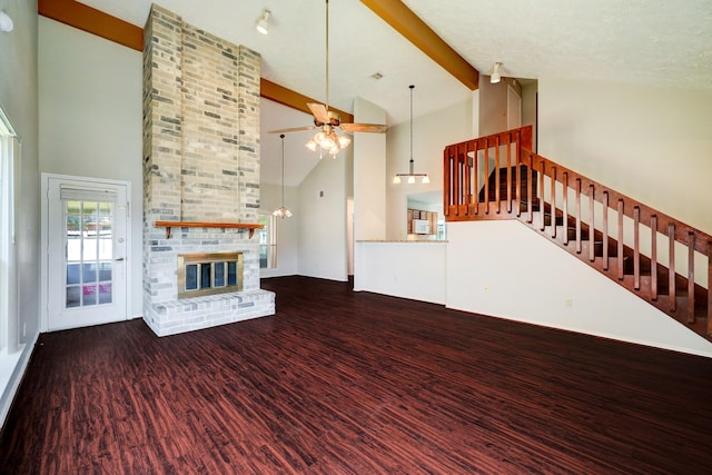 unfurnished living room with beam ceiling, dark hardwood / wood-style flooring, a fireplace, and high vaulted ceiling