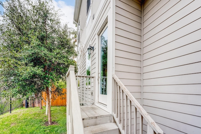 entrance to property with a lawn