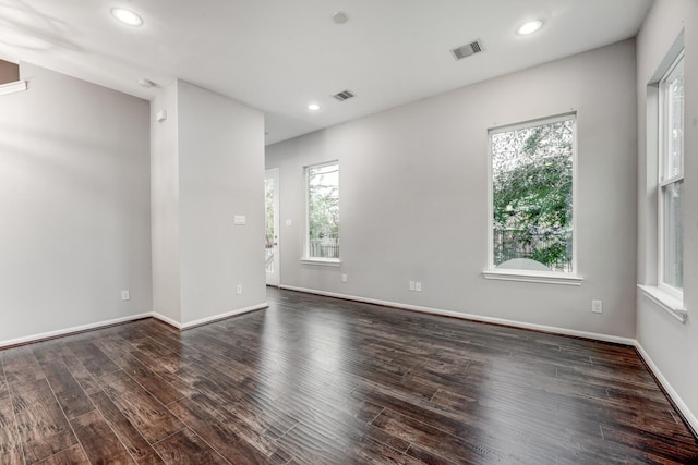 spare room featuring dark wood-type flooring