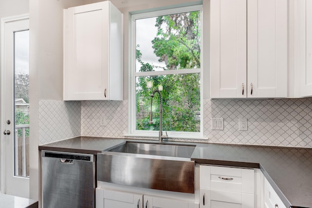 kitchen featuring tasteful backsplash, dishwasher, white cabinets, and plenty of natural light