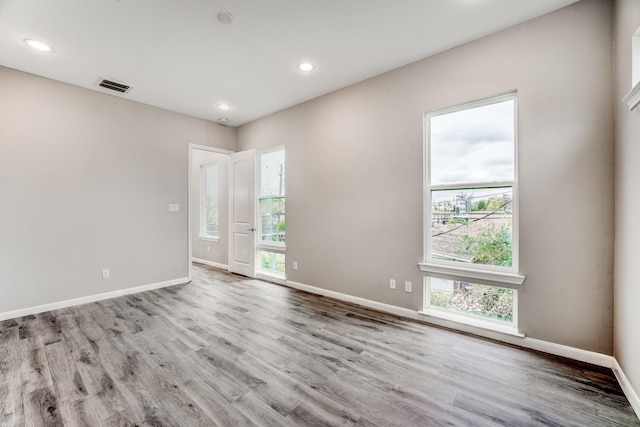 empty room with light hardwood / wood-style floors