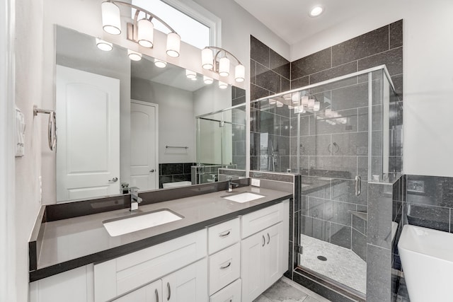 bathroom featuring separate shower and tub and vanity