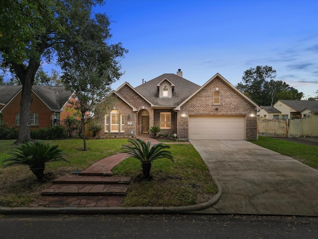 view of front facade with a lawn and a garage