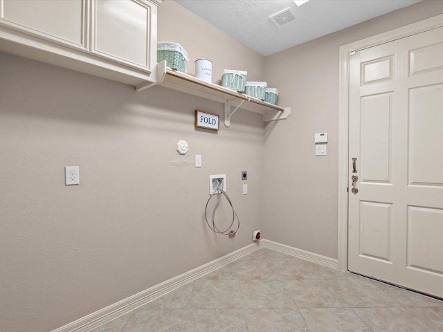 laundry area featuring cabinets, hookup for a washing machine, hookup for an electric dryer, hookup for a gas dryer, and light tile patterned flooring