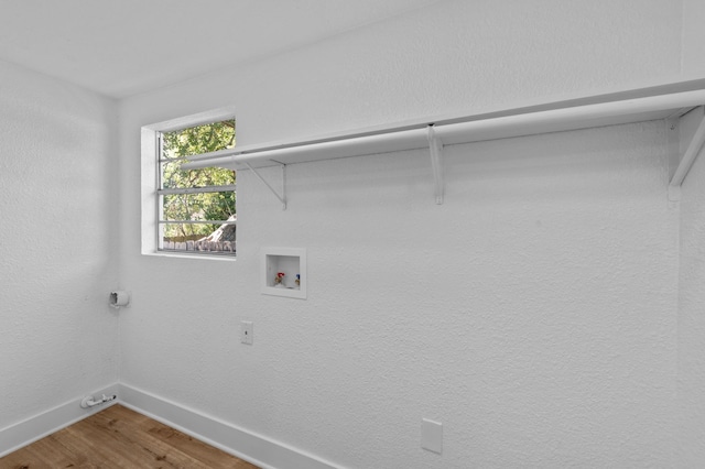 washroom with wood-type flooring and washer hookup