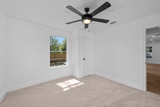 carpeted empty room featuring ceiling fan