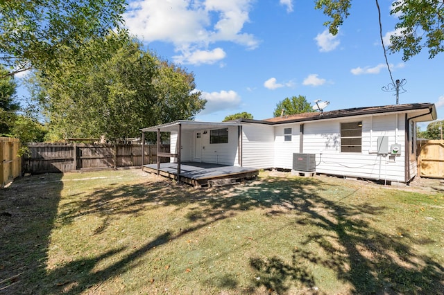 back of house featuring a yard, cooling unit, and a wooden deck