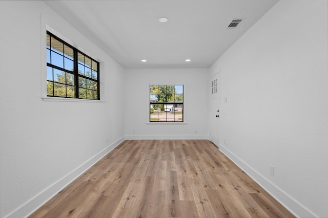 unfurnished room with light hardwood / wood-style flooring