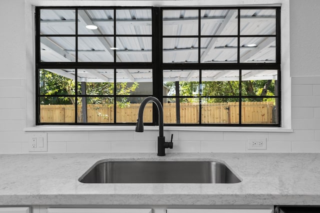 details with light stone countertops and sink