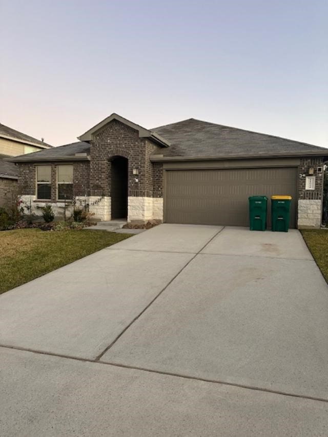 view of front facade featuring a lawn and a garage