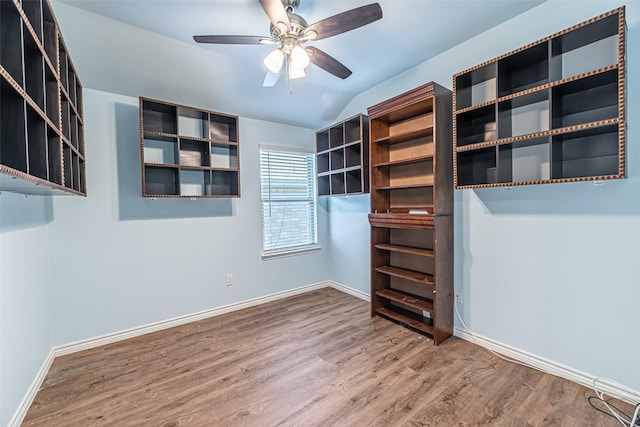 walk in closet with ceiling fan, lofted ceiling, and hardwood / wood-style flooring