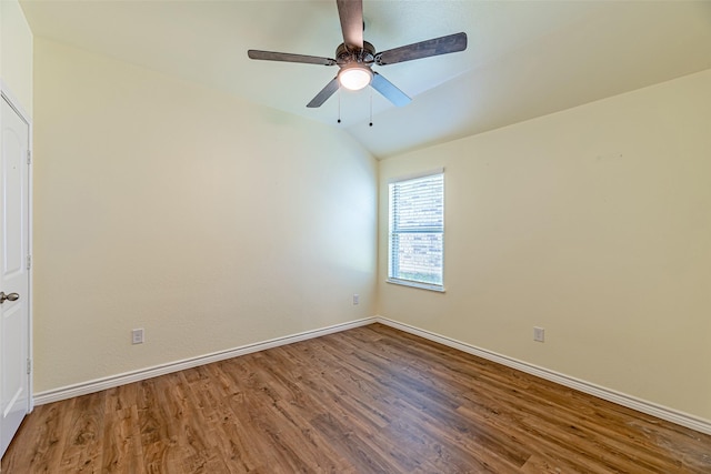 spare room featuring wood-type flooring, ceiling fan, and lofted ceiling