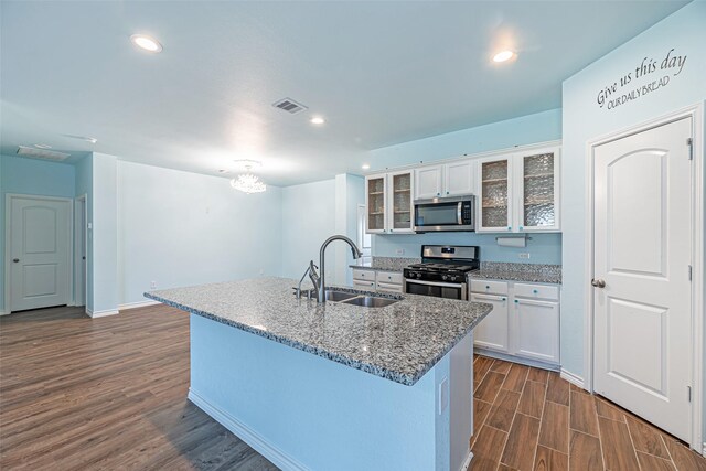 kitchen featuring white cabinets, appliances with stainless steel finishes, dark hardwood / wood-style floors, and sink