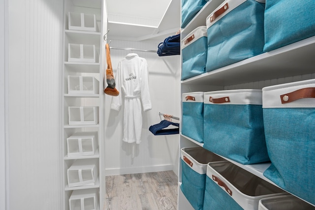 walk in closet with light wood-type flooring