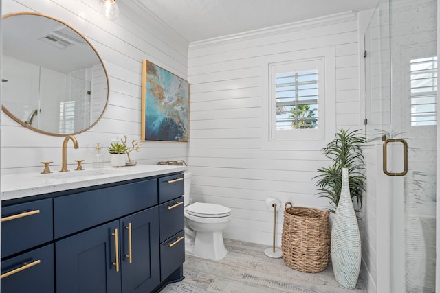 bathroom with hardwood / wood-style flooring, vanity, a healthy amount of sunlight, and a shower with door