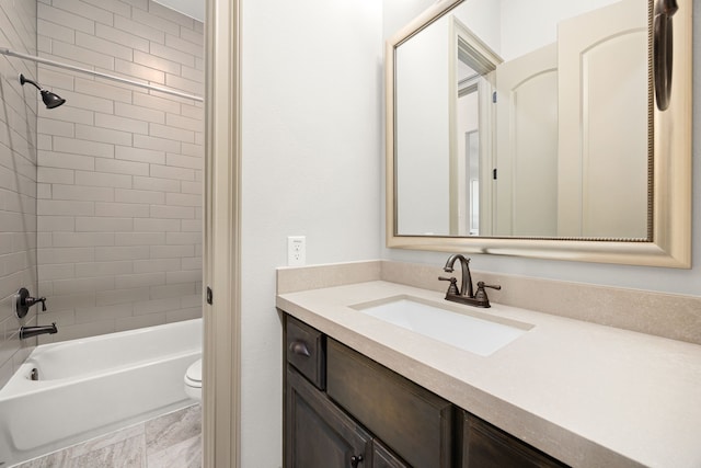 full bathroom with vanity, toilet, and tiled shower / bath