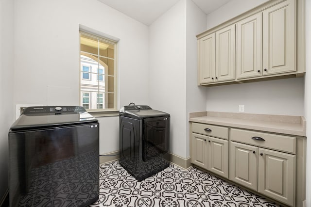 clothes washing area with cabinets, light tile patterned flooring, and independent washer and dryer