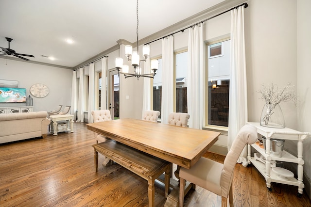 dining room with hardwood / wood-style flooring, ceiling fan with notable chandelier, and ornamental molding