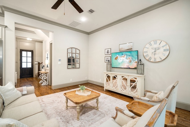 living room featuring crown molding, ceiling fan, and hardwood / wood-style flooring