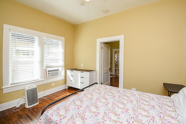 bedroom with dark hardwood / wood-style floors, ceiling fan, and cooling unit