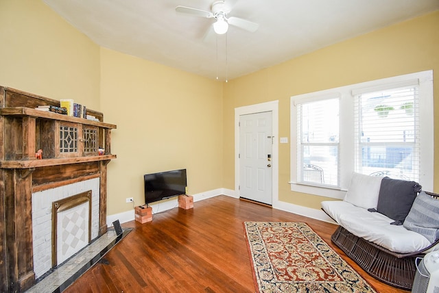 living room with ceiling fan and dark wood-type flooring