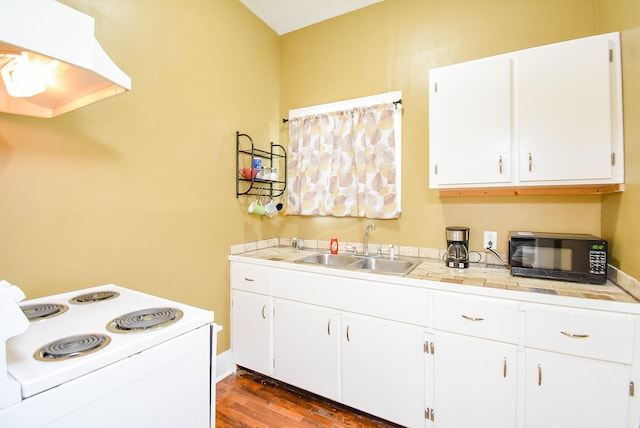 kitchen featuring white electric range oven, dark hardwood / wood-style floors, white cabinetry, and sink