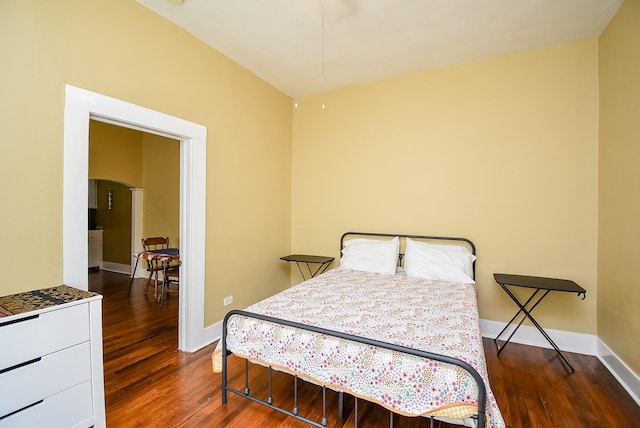 bedroom with dark hardwood / wood-style flooring