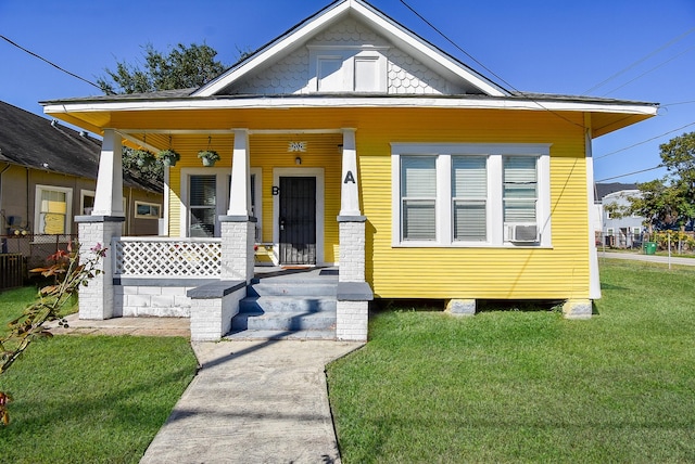 view of front of house with a porch, cooling unit, and a front yard