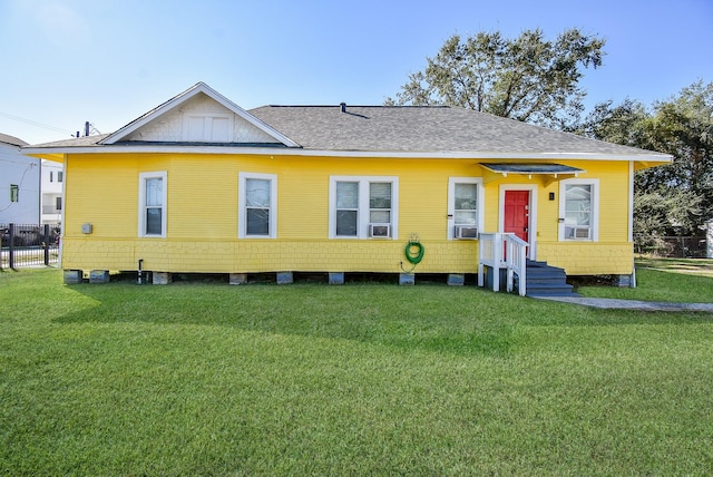 view of front of home featuring cooling unit and a front lawn