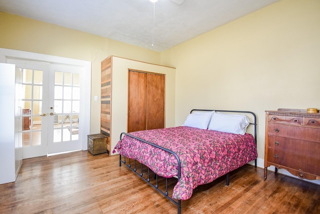 bedroom with hardwood / wood-style floors, french doors, a closet, and ceiling fan