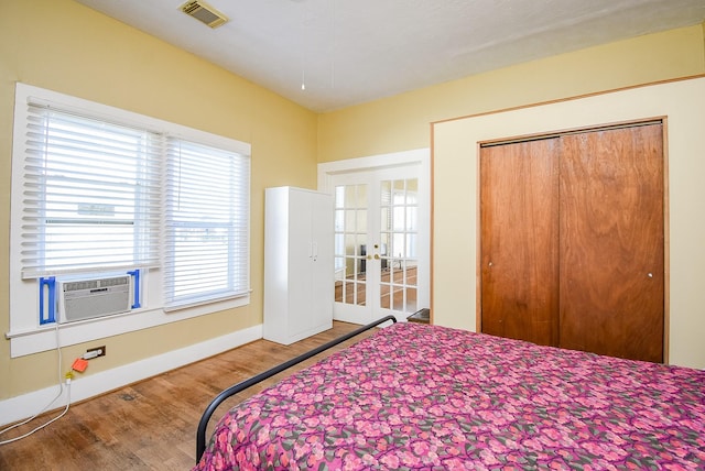 bedroom featuring a closet, hardwood / wood-style flooring, and cooling unit