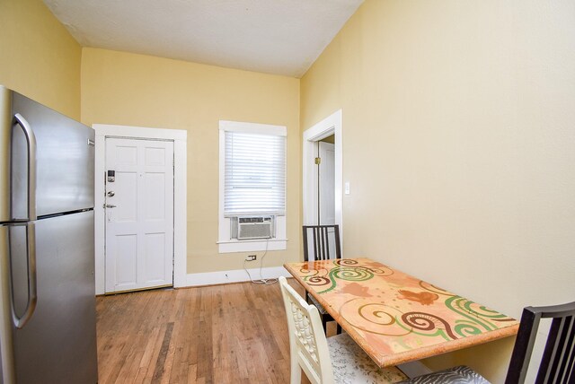 kitchen with stainless steel fridge, light hardwood / wood-style flooring, and cooling unit