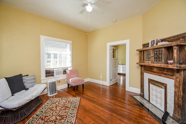 living area with ceiling fan and dark wood-type flooring