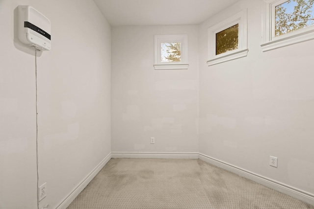 unfurnished room featuring light colored carpet