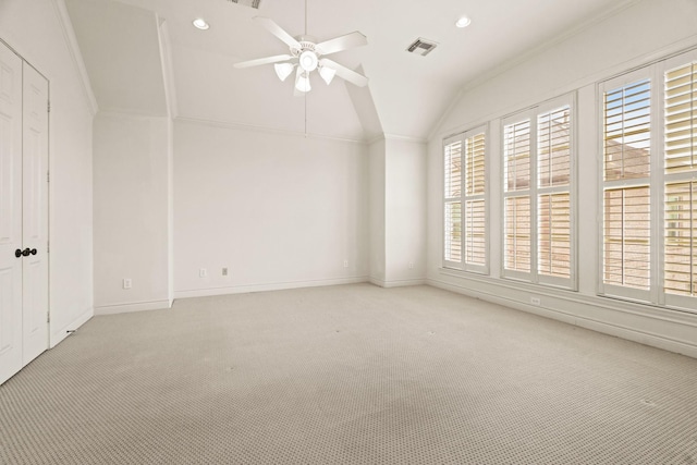 interior space featuring ceiling fan, crown molding, light colored carpet, and lofted ceiling